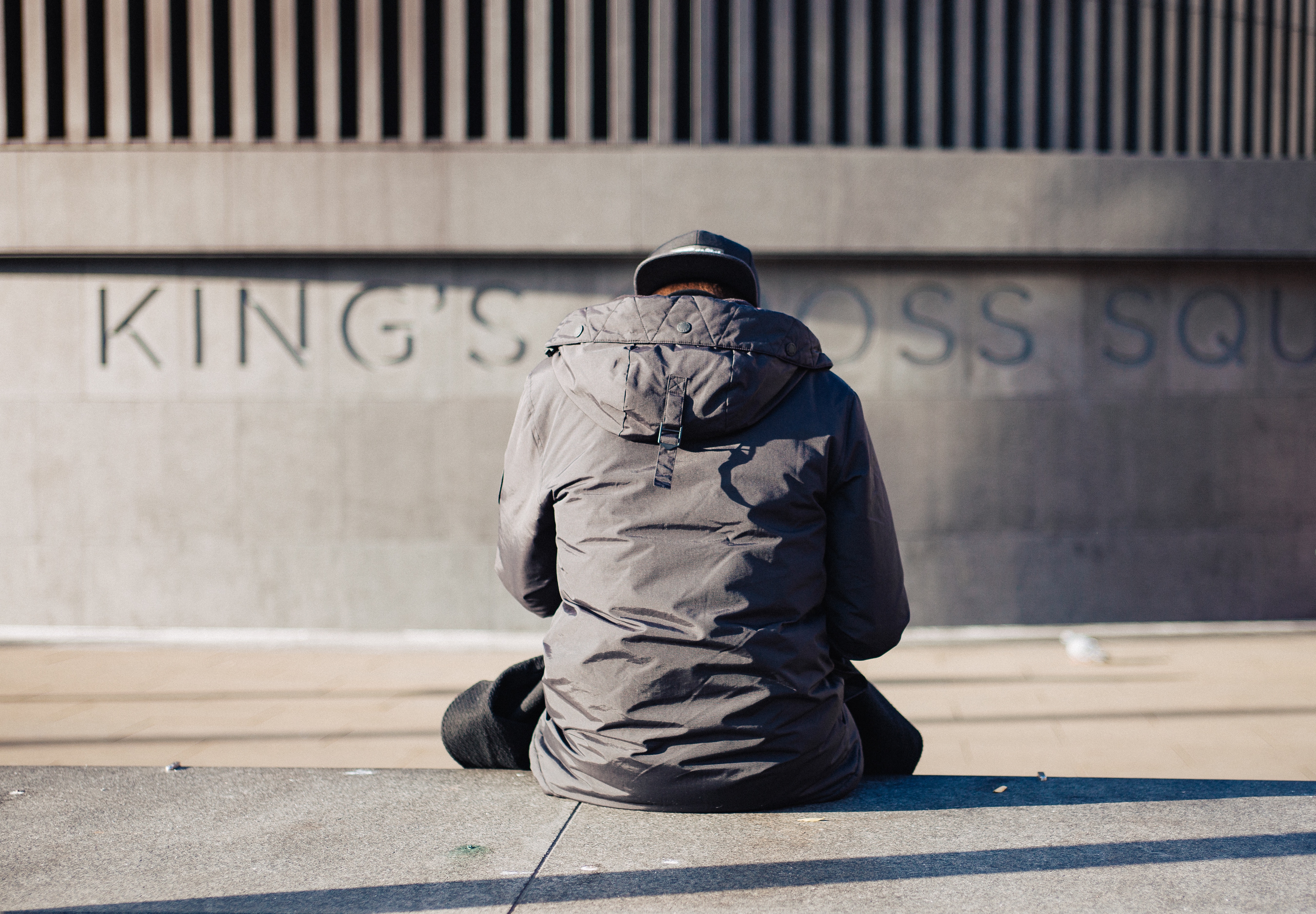 Man standing against a wall